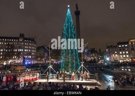 London, UK. 4th December, 2014. The annual lighting of the Trafalgar Square Christmas Tree took place today hosted by the Lord Mayor of Westminster, Cllr Audrey Lewis, who invited the Governing Mayor of Oslo to turn on the Christmas lights. The tree is donated by the City of Oslo to the people of London each year as a token of gratitude for Britain’s support during the Second World War. Pictured: Crowds gather around the Christmas tree in Trafalgar Square. Credit:  Lee Thomas/Alamy Live News Stock Photo