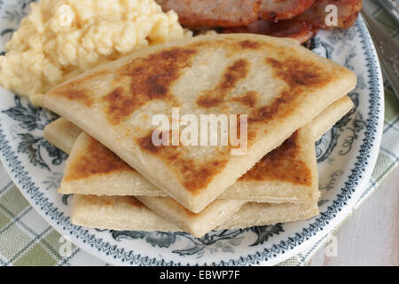 Irish potato farls or potato cakes with bacon and scrambled eggs Stock Photo
