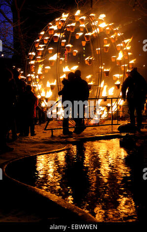 people watching burning globe at a winter event, Canada, Ontario, Toronto Stock Photo