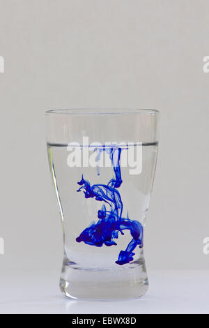 dispersion of blue ink in water glas, Germany Stock Photo