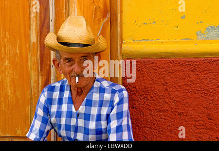 Portrait of a old man, in a cowboy hat with feather, with beard, front view  - dark isolated silhouette Stock Photo - Alamy