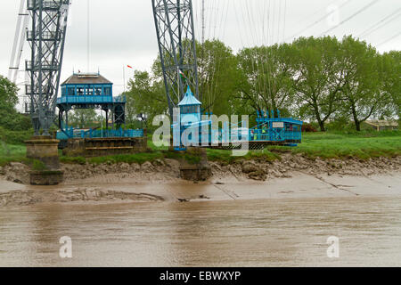 Historic Newport transporter bridge with gondola suspended from immense web of cables carrying vehicles over River Usk in Wales Stock Photo