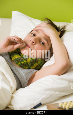 sick boy with fiver in bed Stock Photo