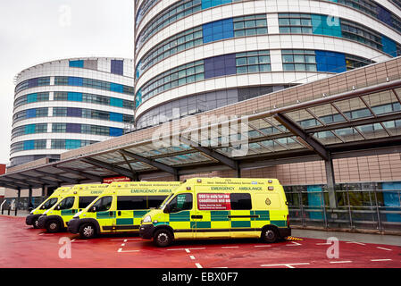 NHS Ambulances wait outside the QE Hospital Birmingham Accident and Emergency department or A&E dept. West Midlands Ambulance. Stock Photo