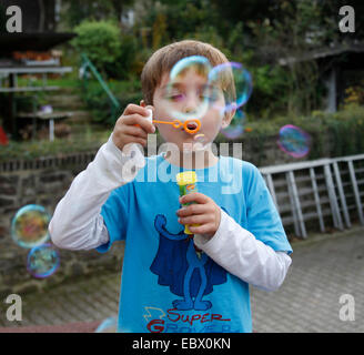 small boy making soap bubbles, Germany Stock Photo