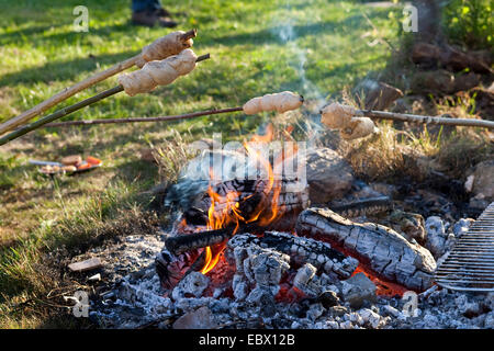 children baking bread over a campfire Stock Photo