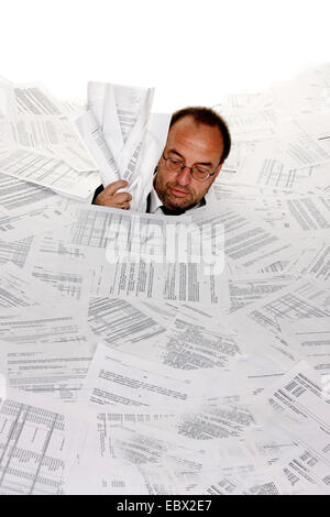 business man bogging in a heap of text documents to the neck Stock Photo