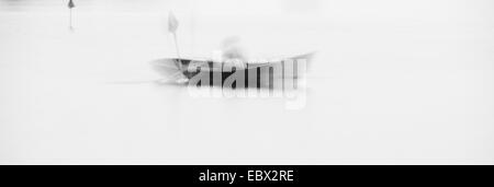 Man in rowboat on lake in Sweden, blurred motion. Stock Photo