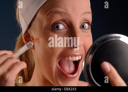 young woman with a injection of botox in her hand Stock Photo