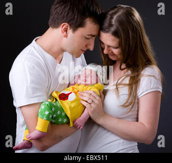 Happy young parents and newborn girl Stock Photo