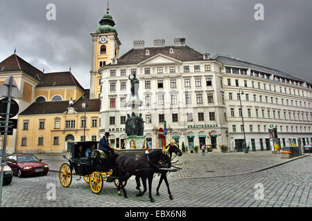 cab, fiaker, with tourists in front of the Austria well, Austria, Freyung, Vienna Stock Photo
