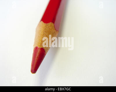 red pencil on a blank white sheet of paper Stock Photo