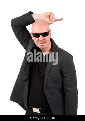 bald headed man with sunglasses pointing with his index finger to the side Stock Photo