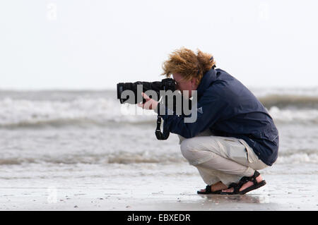 female nature photographer in action, USA, Florida, Sanibel Island Stock Photo