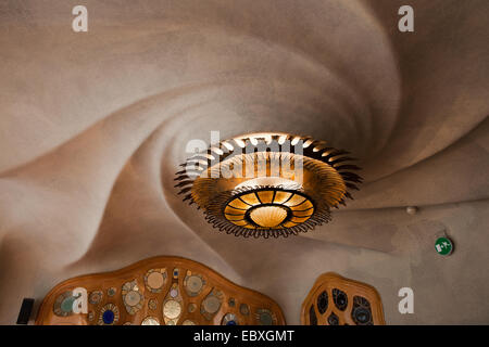 Casa Batllo in Barcelona, Spain. The sun-shaped overhead lamp and spiral vortex ceiling on the Noble Floor. Stock Photo