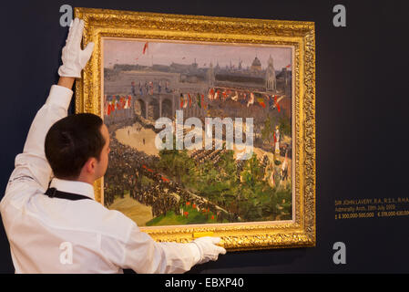 London, UK. 5th December, 2014. World renowned aution house Sotheby's is to offer a collection of British and Continental masters to be sold at auction on December 10th 2014. PICTURED: A Sotheby's gallery technician hangs Sir John Lavery's celebrated painting of the 1919 London Victory Parade at Admiralty Arch. The painting has an estimated value of between £300,000 and £500,000. Credit:  Paul Davey/Alamy Live News