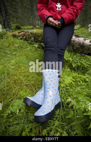 Teenage girl in forest with 'trendy' boots, Norway Stock Photo