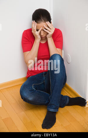 Timid woman symbol of violence in the family Stock Photo