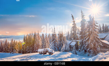 Sunshine, bright day, vehicle and houses covered with fluffy snow Stock Photo