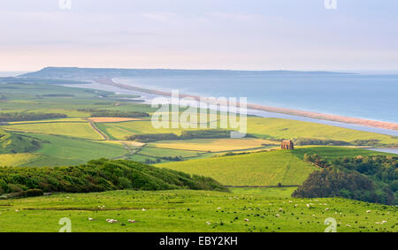 St Catherine's Chapel and rolling countryside with views beyond to Chesil Beach and the Isle of Portland, Dorset, England. Stock Photo