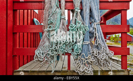 Fishing nets blue and green hanging on the fence or porch red, fishnets carefully picked Stock Photo
