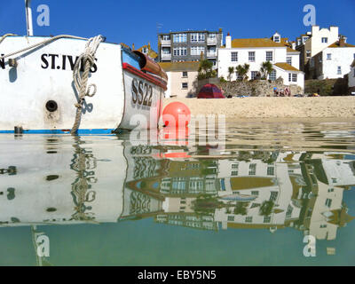 Reflections in calm water St Ives Harbour at high tide Penwith West Cornwall South West England UK Stock Photo