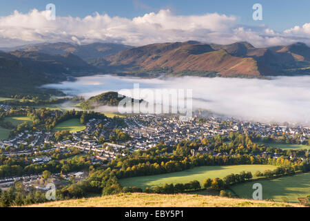 Keswick and mist covered Derwent Water at dawn, Lake District, Cumbria, England. Autumn (October) 2012. Stock Photo