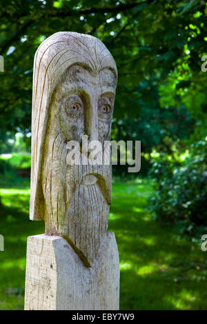 Wood carving of an old man's bearded face Stock Photo