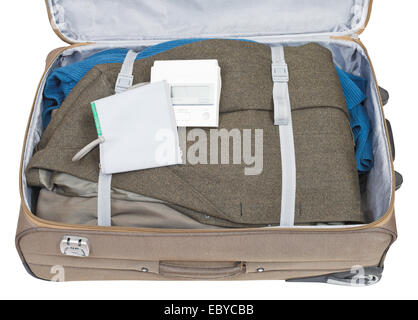 sphygmometer and jacket packed in suitcase isolated on white background Stock Photo
