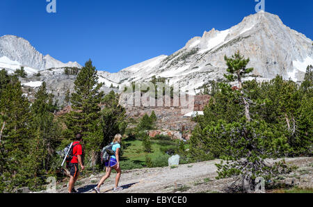 Hikers on trail at 20 Lakes Basin in the Eastern Sierra Stock Photo