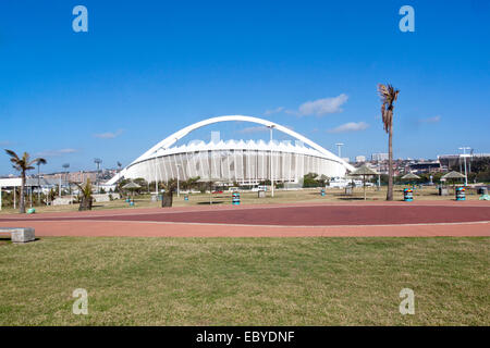 Viewing Moses Mabhida stadium from grass recreational area on beach front  in Durban, South Africa Stock Photo