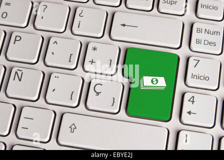 Spanish keyboard with money cash icon over green background button. Image with clipping path for easy change the key color and e Stock Photo