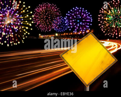 Happy New Year fireworks and city cars highway lights with copy space in yellow road sign. Stock Photo