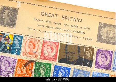 An old fully illustrated stamp album with stamps from Great Britain Stock Photo