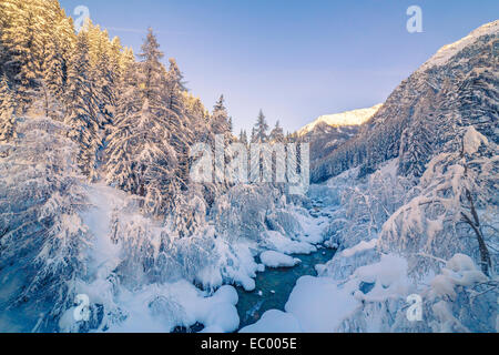 Winter landscape with river, snow and tree on sunset Stock Photo