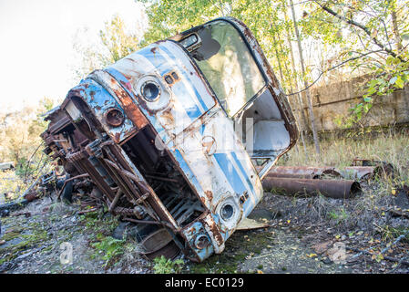 bus wreck in JUPITER factory in Pripyat abandoned city, Chernobyl Exclusion Zone, Ukraine Stock Photo