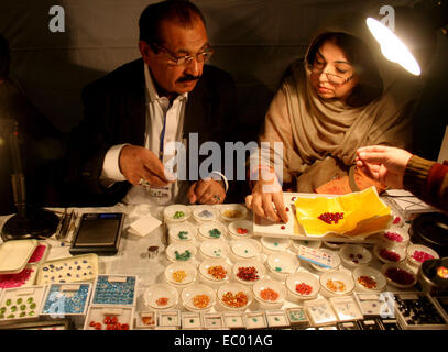 Peshawar. 6th Dec, 2014. People visit the Gems and Jewellery exhibition organized by Gems and Jewellery Development Company at Peshawar Museum in northwest Pakistan's Peshawar, Dec. 6, 2014. Pakistan has precious and expensive stones that are found in northern areas, mountainous terrains of Khyber-Pakhtunkhwa, Balochistan and the areas bordering with Iran and Afghanistan. Credit:  Ahmad Sidique/Xinhua/Alamy Live News Stock Photo