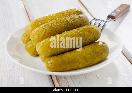 pickled cucumbers in a white bowl . Selective focus Stock Photo