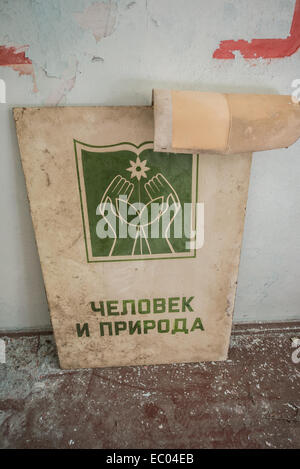 'Human and nature' poster in Middle School Number 3 in Pripyat abandoned city, Chernobyl Exclusion Zone, Ukraine Stock Photo