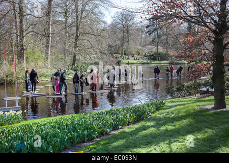 Lisse, Netherlands - April 20, 2013: Tourists walking on water in Keukenhof park, also known as the Garden of Europe, is the wor Stock Photo