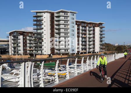 Cyclists on bridge over river Taff, Cardiff Bay, Wales, UK Stock Photo