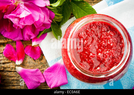 Homemade jam made from damascus petal rose on wooden table. Selective focus Stock Photo