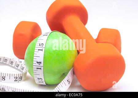 Green apple and a dumbbell on white background Stock Photo