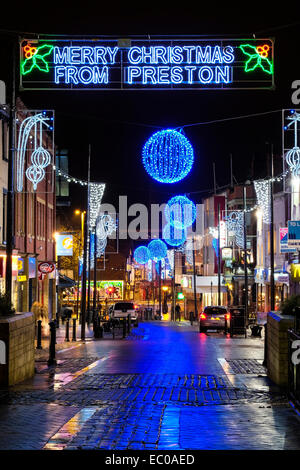 Preston, Lancashire, UK. 6th Dec, 2014. Preston's Christmas Lights are reflected in the wet pavement of the City's Friargate shopping area. Credit:  Paul Melling/Alamy Live News Stock Photo