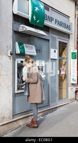 person woman withdrawing money cash machine bank Stock Photo