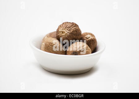 Whole nutmeg (Myristica fragrans) on white background Stock Photo