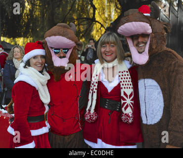 London, UK. 6th Dec, 2014. People dressed as Santa Clause and reindeer at the annual 'SantaCon' event in Camden, north London.  Santacon events take place in various cities around the world in the weeks before Christmas. The parade, which is part flash mob, part pub crawl, has an emphasis on having fun and spreading seasonal good cheer to passers by. Credit:  Michael Preston/Alamy Live News Stock Photo