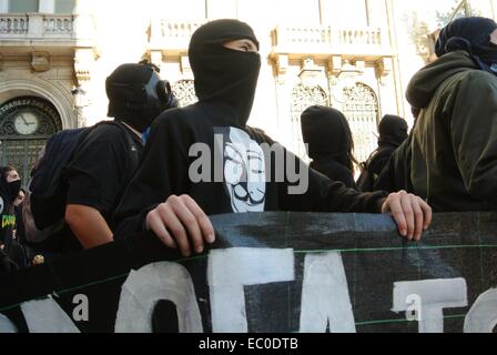 Athens, Greece. 6th Dec, 2014. A demonstrator wears a tshirt with an anonymous mask.A huge demonstration was organised in Athens to commemorate the 6th anniversary of the death of 15y.o. student Alexis Grigoropoulos that was shot by a policeman in Exarhia region of Athens. Credit:  George Panagakis/Pacific Press/Alamy Live News Stock Photo