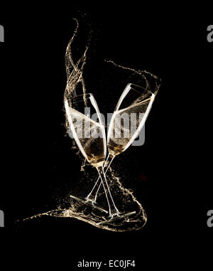 Glasses of champagne with splash, isolated on black background Stock Photo