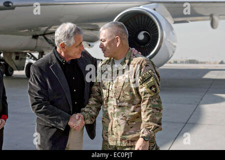 US Secretary of Defense Chuck Hagel is greeted by US Army Gen. John F. Campbell, commander of the International Security Assistance Force and US Forces-Afghanistan on arrival December 6, 2014 in Kabul, Afghanistan. Stock Photo